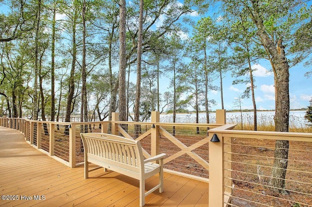 wooden terrace featuring a water view