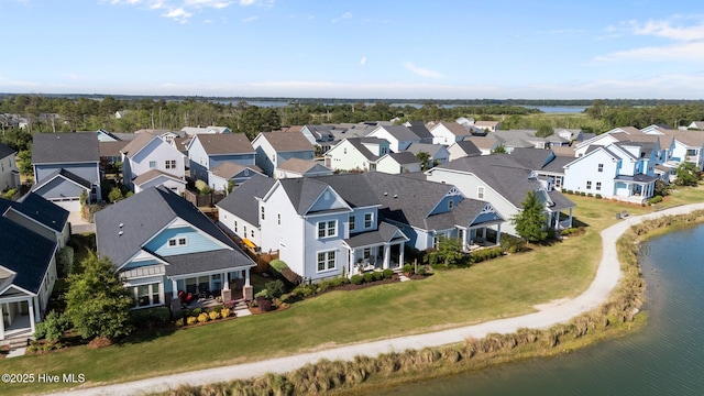 aerial perspective of suburban area with a large body of water