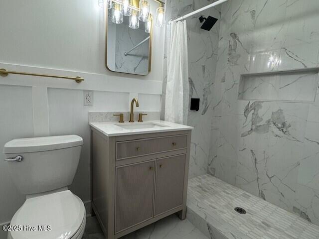 205 Mulberry St, Winton, NC 27986 - bathroom featuring marble finish floor, vanity, a marble finish shower, and toilet