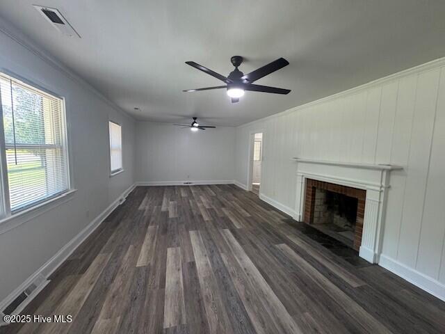 205 Mulberry St, Winton, NC 27986 - unfurnished living room with a fireplace, visible vents, crown molding, and dark wood-style floors