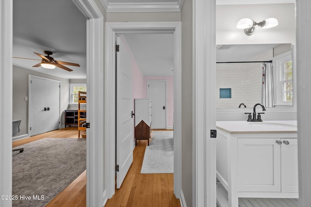 full bathroom with a shower with curtain, ceiling fan, wood finished floors, and vanity