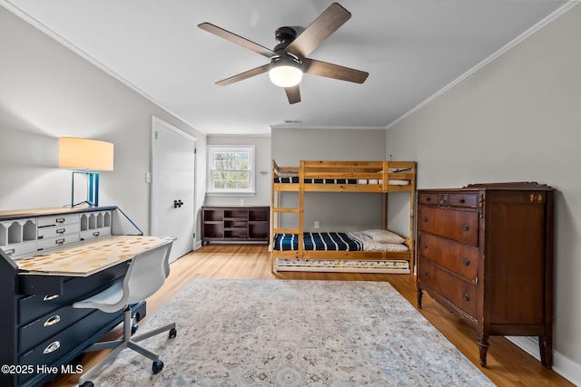 bedroom featuring ornamental molding, a ceiling fan, and wood finished floors