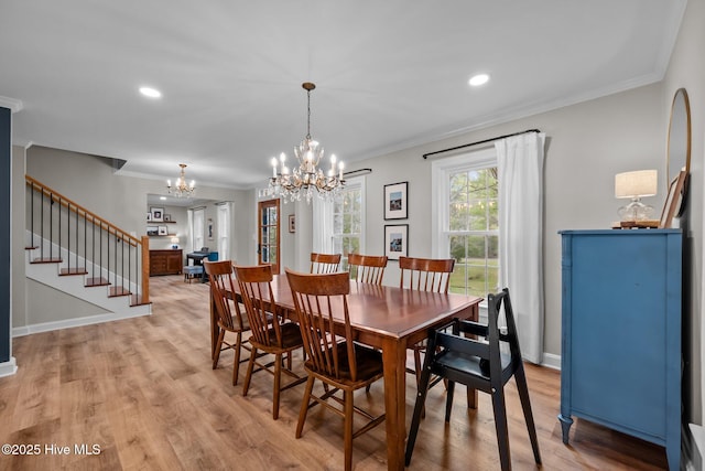 dining space featuring crown molding, baseboards, stairway, light wood finished floors, and a notable chandelier