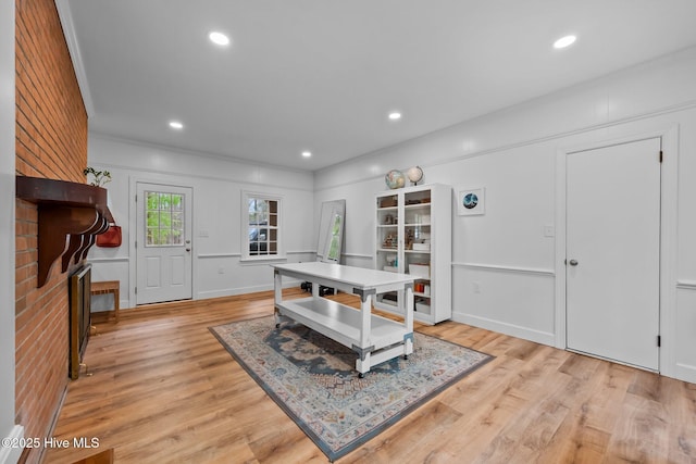 dining area featuring a fireplace, recessed lighting, and light wood-type flooring