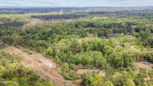 drone / aerial view featuring a forest view