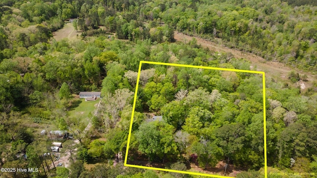 drone / aerial view featuring a wooded view
