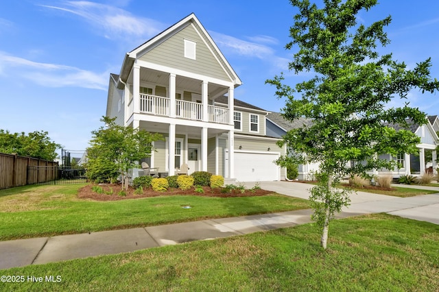 4434 Old Towne St, Wilmington, NC 28412 - greek revival inspired property featuring a balcony, concrete driveway, an attached garage, and a porch
