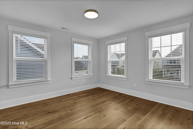 4434 Old Towne St, Wilmington, NC 28412 - unfurnished room with wood finished floors, baseboards, and healthy amount of natural light