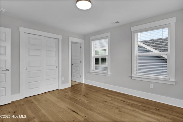 4434 Old Towne St, Wilmington, NC 28412 - unfurnished bedroom featuring wood finished floors, baseboards, and a closet