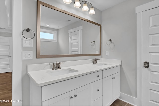 4434 Old Towne St, Wilmington, NC 28412 - bathroom featuring double vanity, wood finished floors, and baseboards
