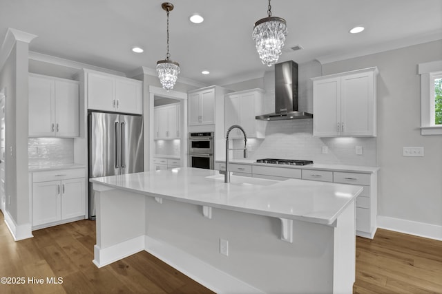 4434 Old Towne St, Wilmington, NC 28412 - kitchen with wall chimney exhaust hood, stainless steel appliances, a chandelier, a sink, and decorative backsplash