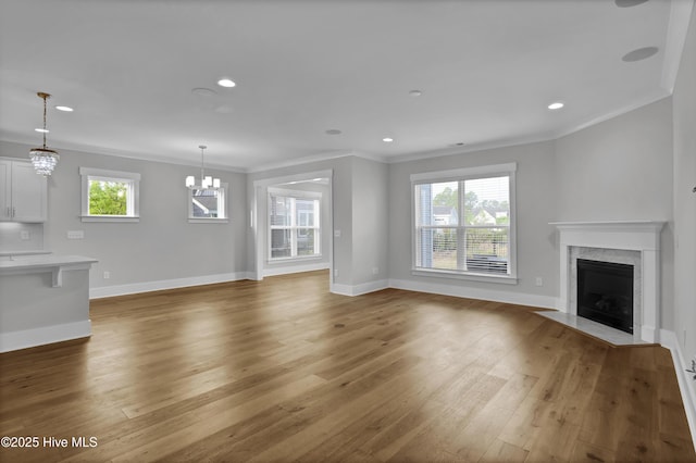 4434 Old Towne St, Wilmington, NC 28412 - unfurnished living room with crown molding, plenty of natural light, a fireplace, baseboards, and wood finished floors