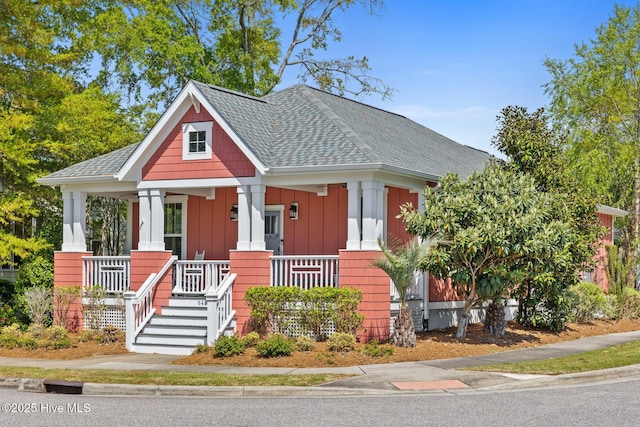 6460 Carrick Bend Trl SW, Ocean Isle Beach, NC 28469 - view of front of property featuring board and batten siding, covered porch, and a shingled roof