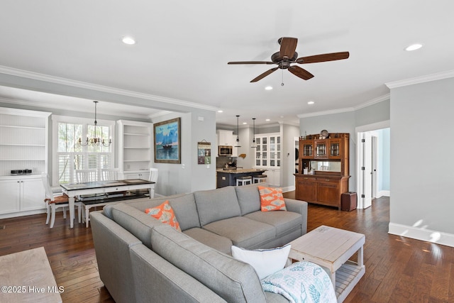 6460 Carrick Bend Trl SW, Ocean Isle Beach, NC 28469 - living room featuring a ceiling fan, dark wood-style floors, a chandelier, ornamental molding, and recessed lighting