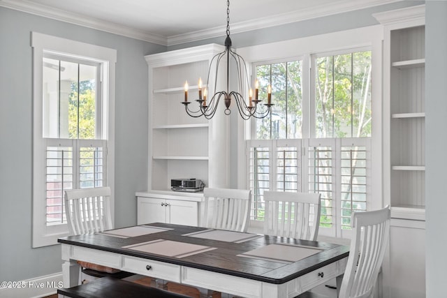 6460 Carrick Bend Trl SW, Ocean Isle Beach, NC 28469 - dining room featuring a chandelier, built in features, ornamental molding, and plenty of natural light