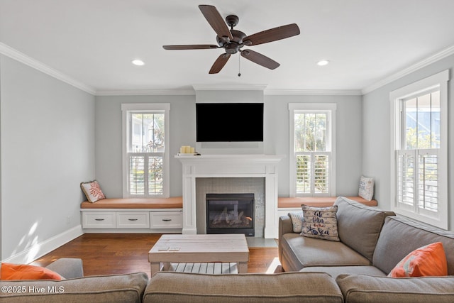 6460 Carrick Bend Trl SW, Ocean Isle Beach, NC 28469 - living room featuring dark wood-style floors, a glass covered fireplace, recessed lighting, ornamental molding, and a ceiling fan