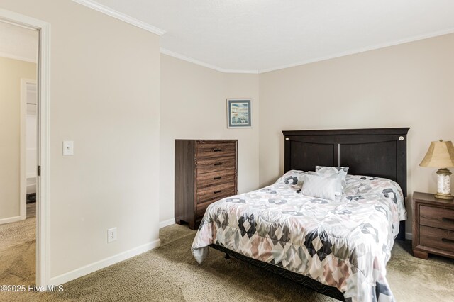 bedroom with baseboards, crown molding, and light colored carpet