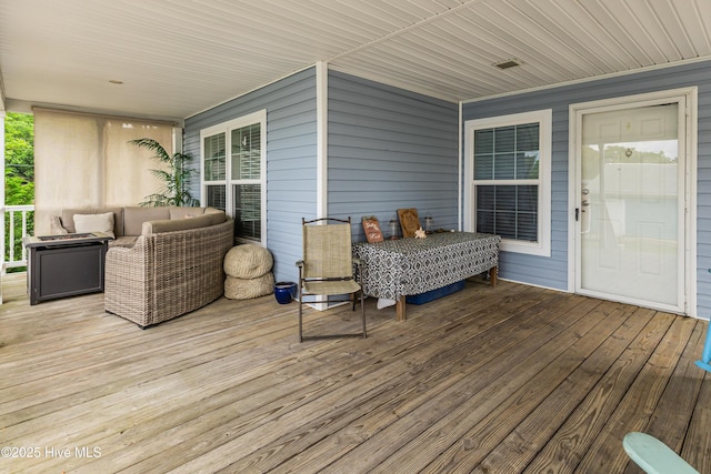wooden deck featuring an outdoor living space