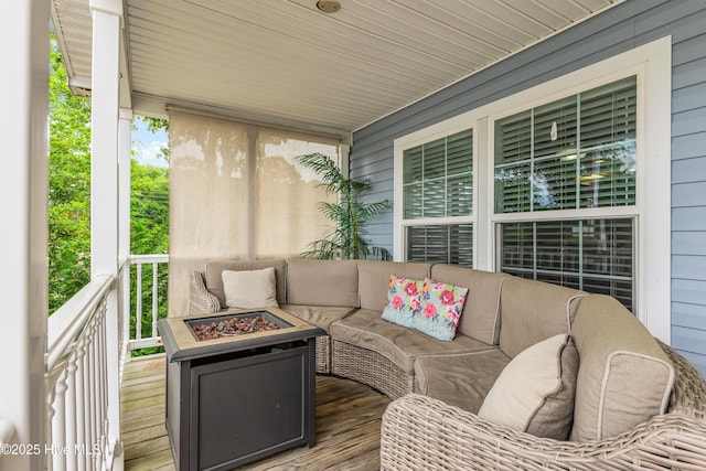 exterior space with an outdoor living space with a fire pit