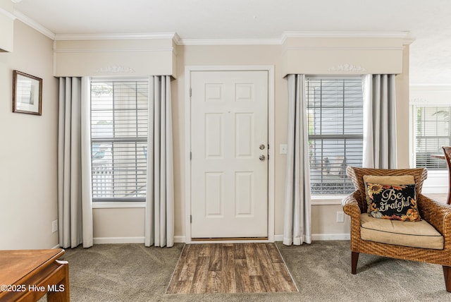 entryway with dark colored carpet, ornamental molding, and baseboards