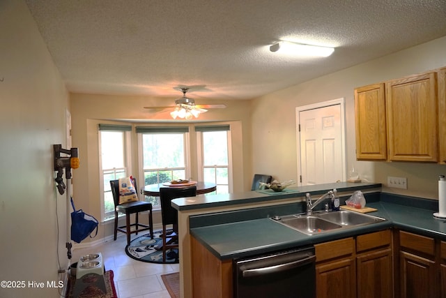 10 Flint Ct Unit 12, Pinehurst, NC 28374 - kitchen featuring dishwasher, a sink, a peninsula, dark countertops, and a textured ceiling