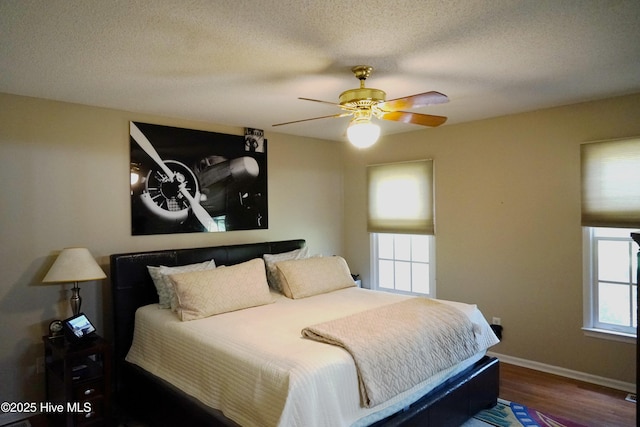 10 Flint Ct Unit 12, Pinehurst, NC 28374 - bedroom featuring wood finished floors, baseboards, a ceiling fan, and a textured ceiling