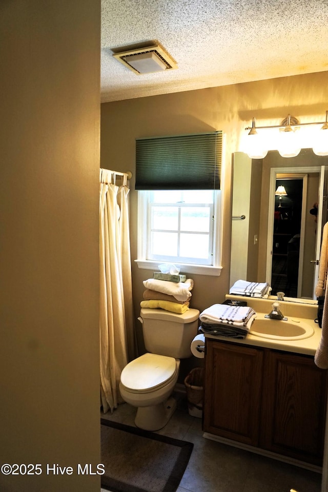 10 Flint Ct Unit 12, Pinehurst, NC 28374 - bathroom with vanity, toilet, a textured ceiling, and curtained shower