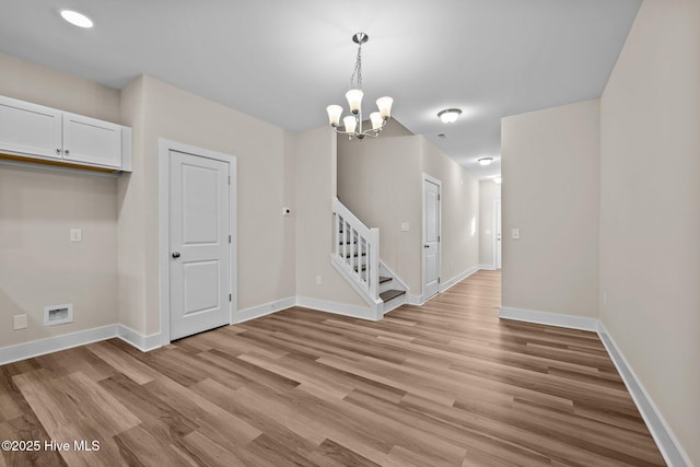 806 Pryor St Unit 50, Mebane, NC 27302 - unfurnished dining area with light wood-style flooring, baseboards, an inviting chandelier, and stairs