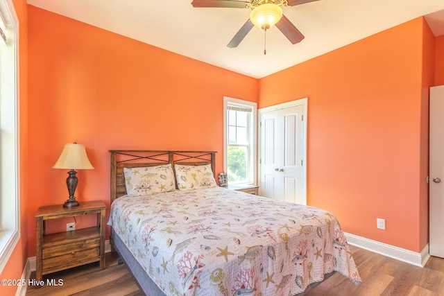 210 Gysgt Dw Boatman Dr Unit 1, North Topsail Beach, NC 28460 - bedroom featuring wood finished floors, baseboards, a closet, and ceiling fan
