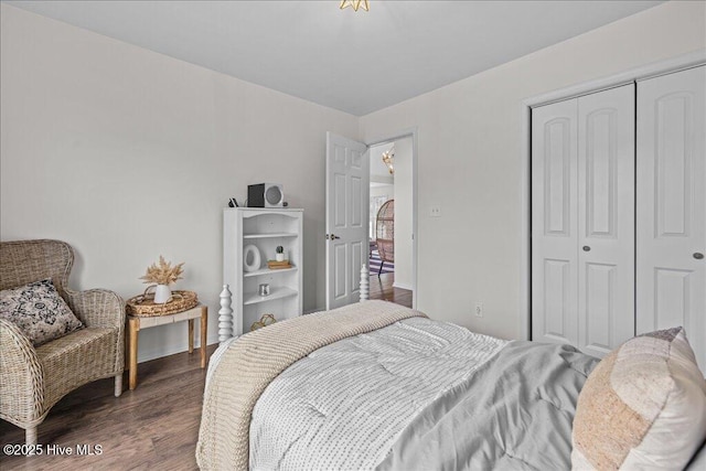 bedroom featuring a closet and dark wood finished floors