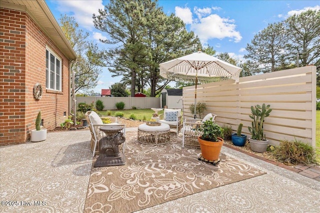 view of patio / terrace with a fenced backyard, a storage shed, and an outdoor structure