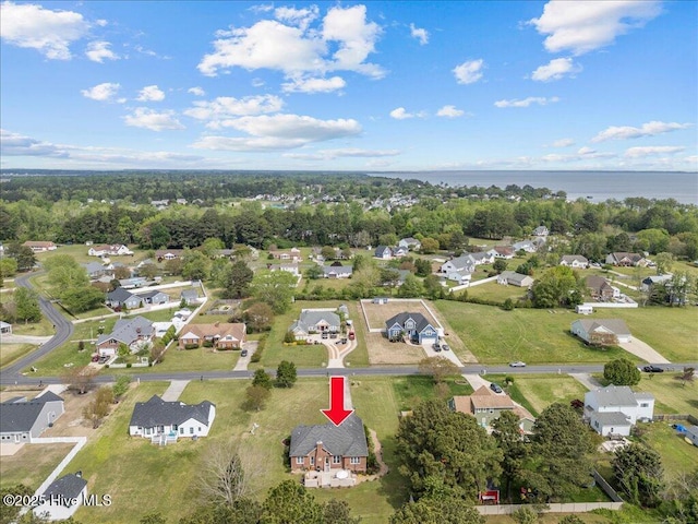 aerial overview of property's location with nearby suburban area and a large body of water