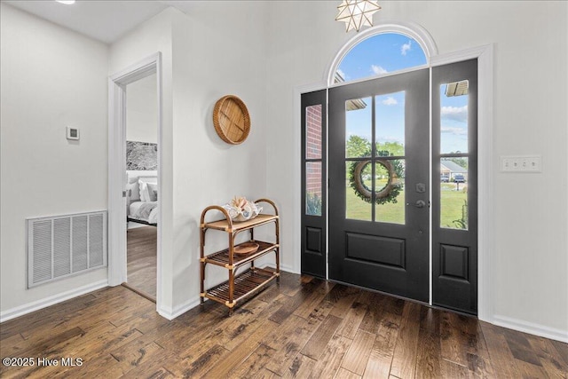 entrance foyer featuring wood finished floors and baseboards