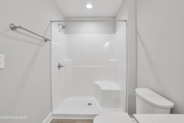 full bathroom with walk in shower, vanity, and toilet