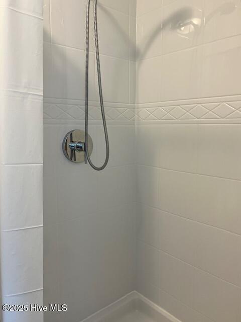 full bathroom with a tile shower