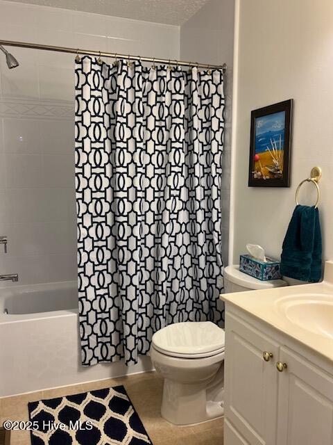 bathroom featuring vanity, tile patterned flooring, toilet, and shower / tub combo with curtain