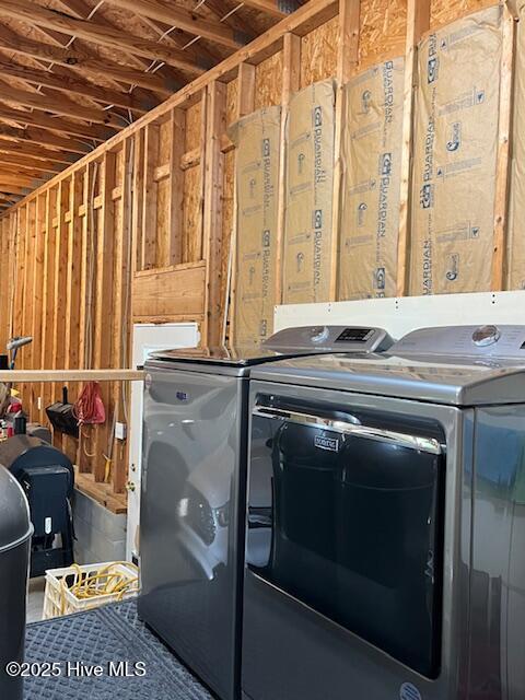 clothes washing area with laundry area and washer and dryer