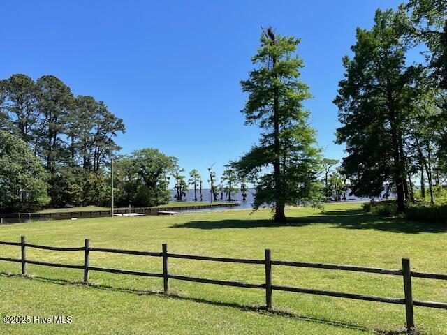 view of yard with a water view and fence