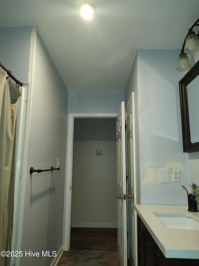bathroom featuring wood finished floors and vanity