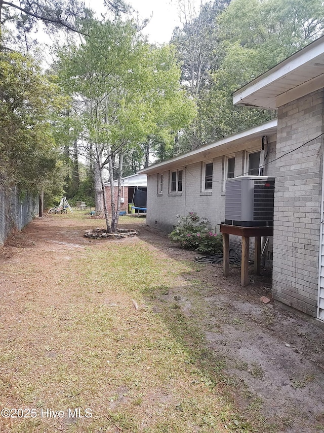 view of yard with central air condition unit