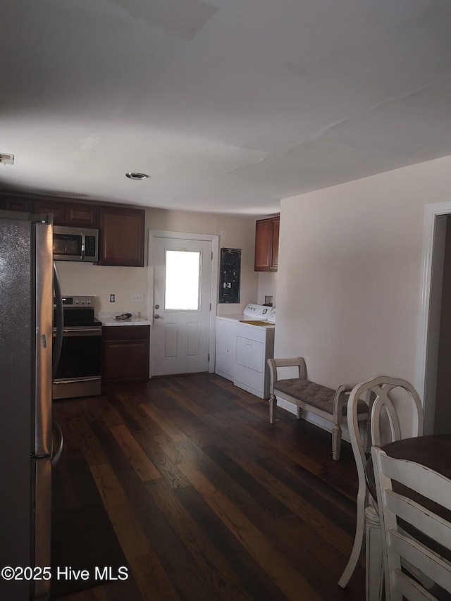 1714 Dillahunt St, New Bern, NC 28560 - kitchen featuring appliances with stainless steel finishes, washer / clothes dryer, dark wood-type flooring, and light countertops