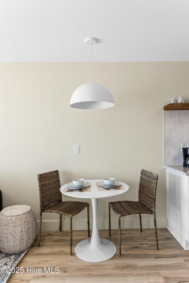dining area with wood finished floors and baseboards