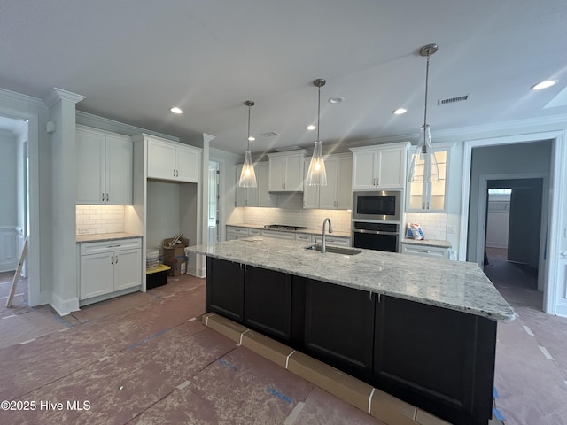 kitchen featuring a sink, tasteful backsplash, ornamental molding, white cabinets, and recessed lighting