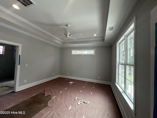 empty room with a tray ceiling, baseboards, ceiling fan, ornamental molding, and recessed lighting