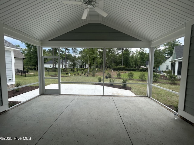 unfurnished sunroom featuring ceiling fan and vaulted ceiling