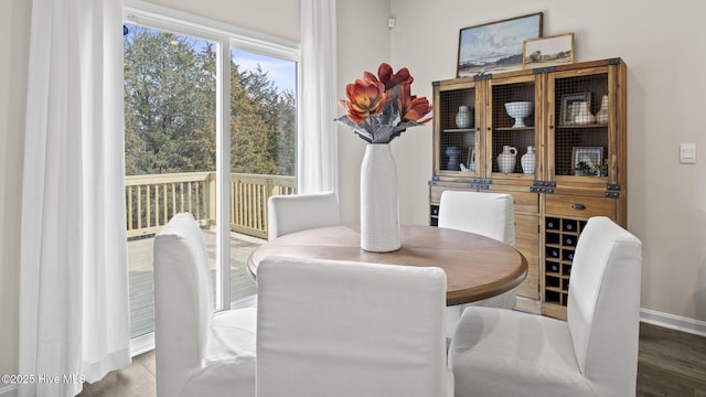 dining room featuring wood finished floors and baseboards