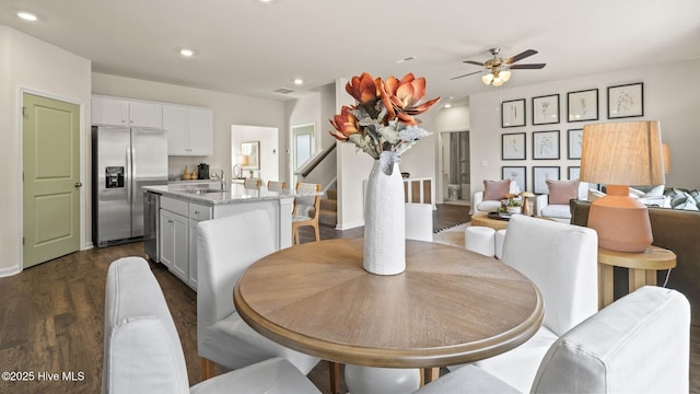 dining room featuring stairway, a ceiling fan, dark wood finished floors, visible vents, and recessed lighting