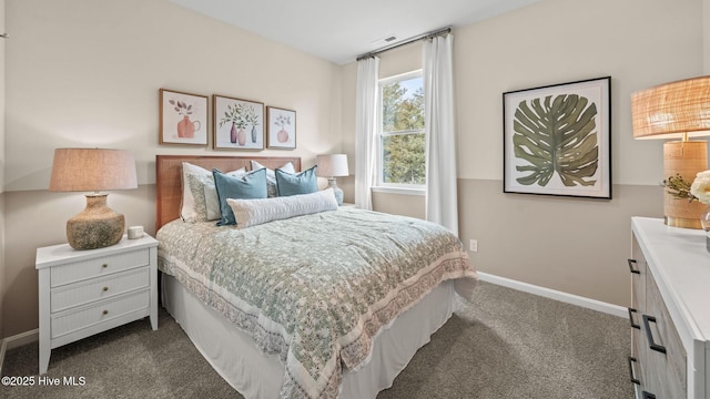 bedroom with baseboards, dark colored carpet, and visible vents