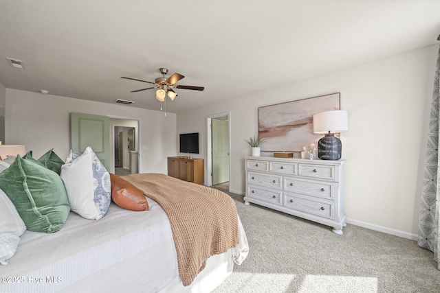 bedroom featuring baseboards, a ceiling fan, visible vents, and light colored carpet