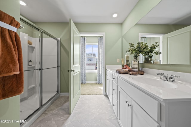 bathroom featuring baseboards, vanity, recessed lighting, and a shower stall